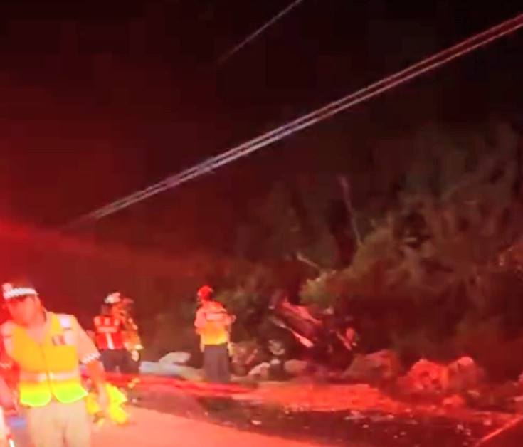Personal de emergencias trabajando en el rescate del vehículo siniestrado.