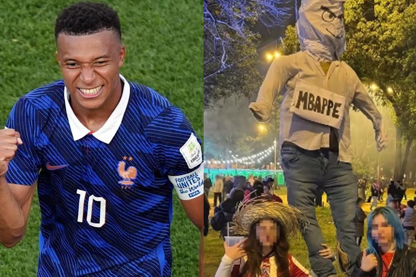 Asistentes celebran en una plaza pública de Paraguay mientras el muñeco que representa la polémica de Kylian Mbappé es consumido por el fuego.